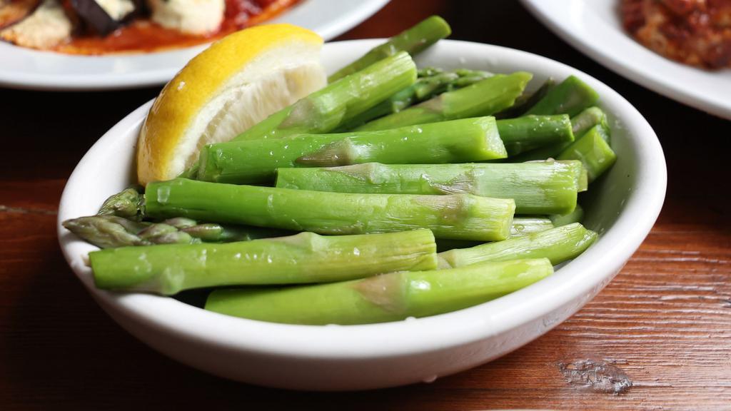 Asparagus · Tender spears of asparagus topped with a light lemon vinaigrette. Vegan and gluten free.