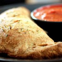 Milano Calzone · Grilled chicken, roasted peppers, pesto, artichoke, ricotta, spinach, feta cheese and mozzar...