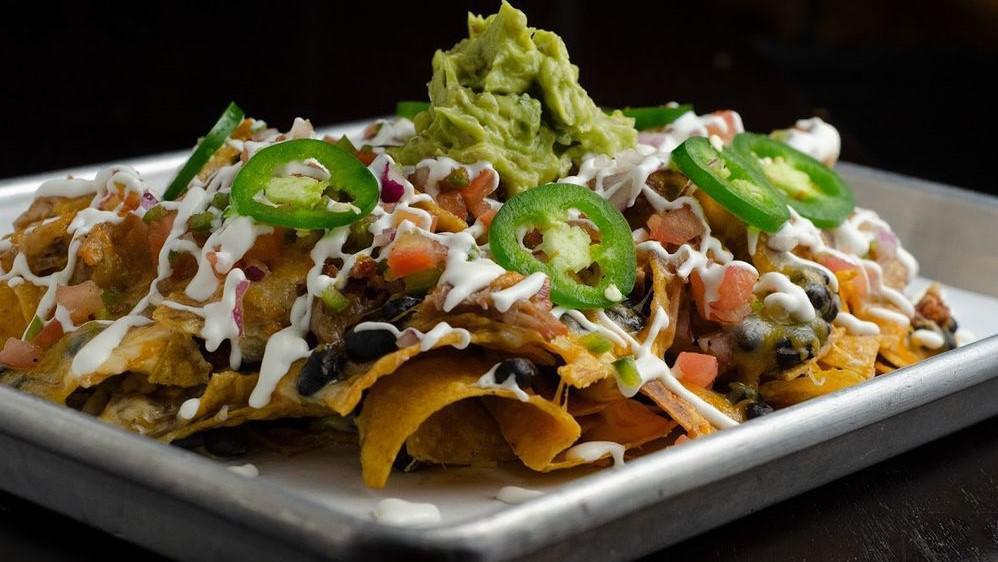 Cowboy Nachos · House Made Tortilla Chips, Pulled Chicken, Cheese Sauce, Black Beans, Pico de Gallo, Lime Sour Cream, Guacamole and Jalapenos. Substitute Brisket For An Additional Charge.