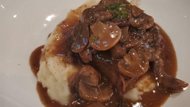 Braised Short Ribs · Served With Garlic Mashed Potato, Sautéed Mushrooms, and Red Wine Reduction.