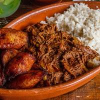  Carne Desmenuzada · Traditional Cuban shredded beef or chicken.