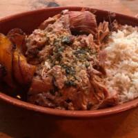 Lechon Asado · Roasted pork, onions and garlic mojo.