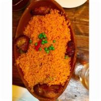 Arroz Con Pollo · Chicken on the bone, yellow rice, sofrito, sweet peas and roasted peppers.