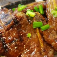Kal-Bi / 엘에이 갈비 · BBQ beef short ribs marinated with soy sauce based signature sauce. Served with Kim chee, ba...