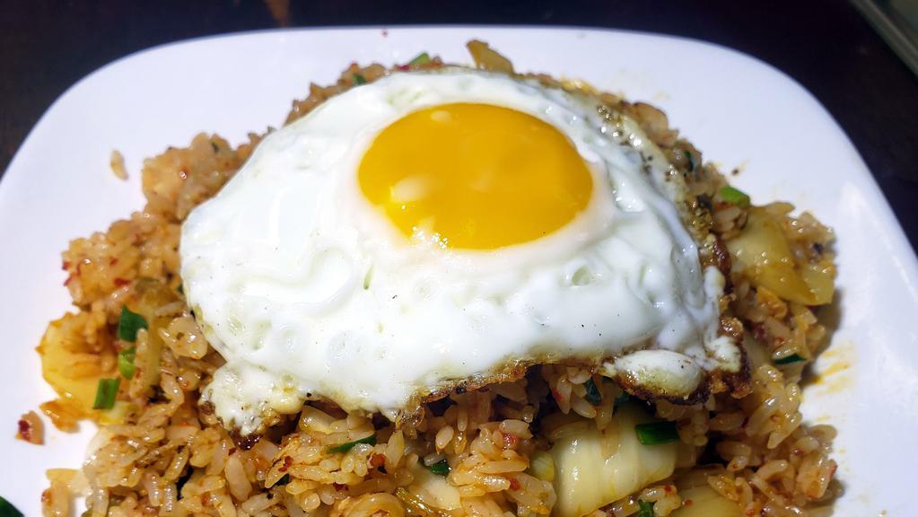 Kim Chee Fried Rice / 김치볶음밥 · Stir-fried white rice with Kim Chee and sunny side up eggs.