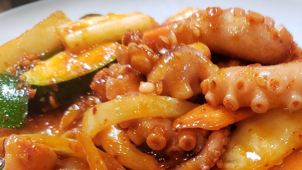 Stir-Fried Octopus / 낙지볶음 · Nahkji Bohk Eum / stir-fried octopus and vegetables with spicy sauce.
served with Kim chee, ban Chan ( vegetables ) and white rice.