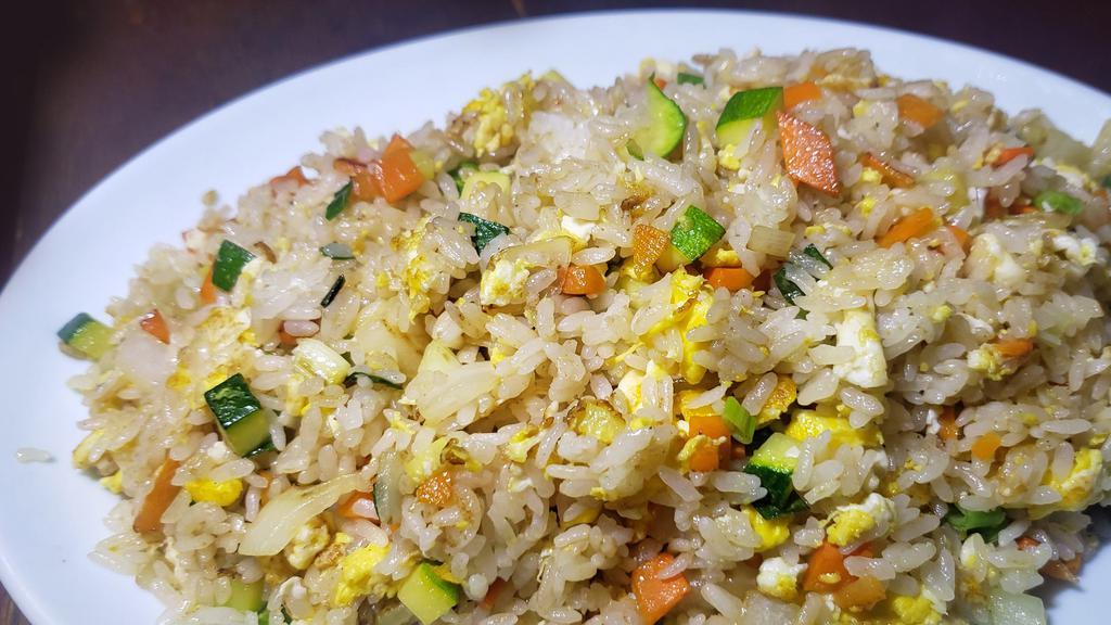 Vegetable Fried Rice / 야채볶음밥 · Stir-fried white rice with eggs and vegetables.
served with Kim Chee.