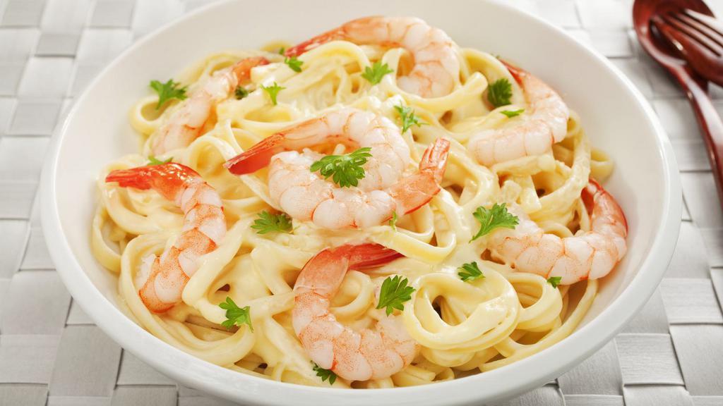 Seafood Fettuccine Alfredo · An aromatic pasta dish consisting of fettuccine with butter, Parmesan cheese, cream, various seafood and seasonings.