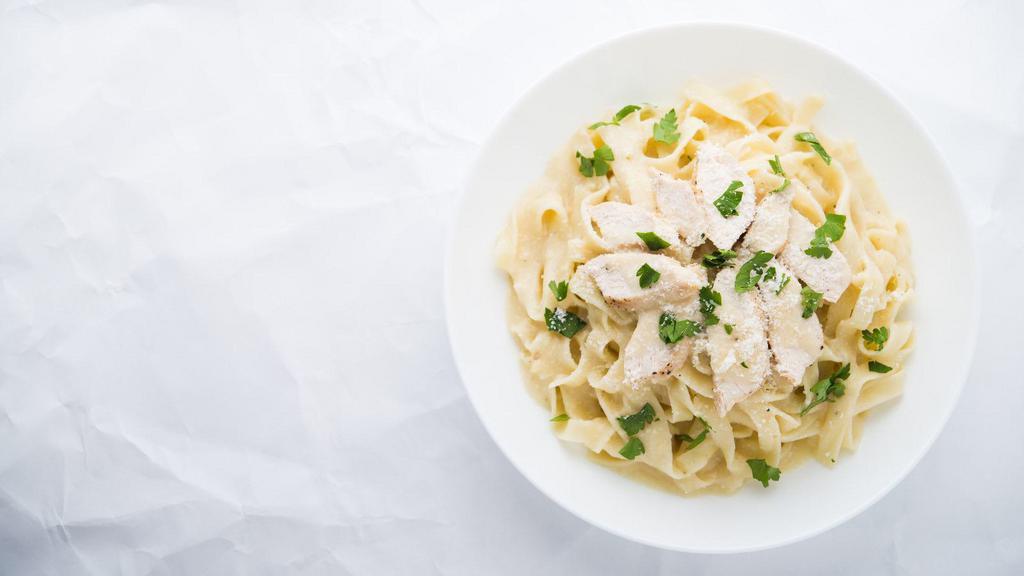 Chicken Fettuccine Alfredo · An aromatic pasta dish consisting of fettuccine with butter, Parmesan cheese, cream, chicken and seasonings.