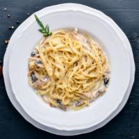 Mushroom Fettuccine Alfredo · An aromatic pasta dish consisting of fettuccine with butter, Parmesan cheese, cream, mushroo...
