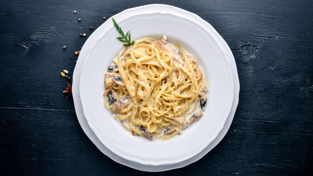 Mushroom Fettuccine Alfredo · An aromatic pasta dish consisting of fettuccine with butter, Parmesan cheese, cream, mushroom and seasonings.