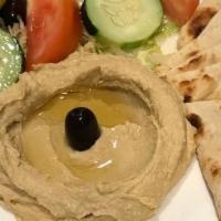 Hummus Platter · Ground chickpeas dip with extra virgin Greek olive oil. Served with pita and green vegetables.