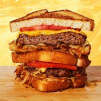 Burger Grilled Cheese · Melted cheddar cheese, beef burger patty, caramelized onions, tomato, and mayo between two s...