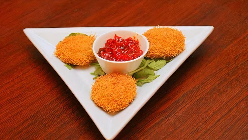 Dahi Ke Kabab · Yogurt dumplings with chopped onions, peppers coated with vermicelli and topped with tangy tomato chutney.