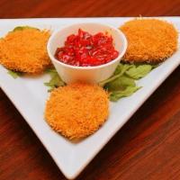 Dahi Ke Kabab · Yogurt dumplings with chopped onions, peppers coated with vermicelli and topped with tangy t...