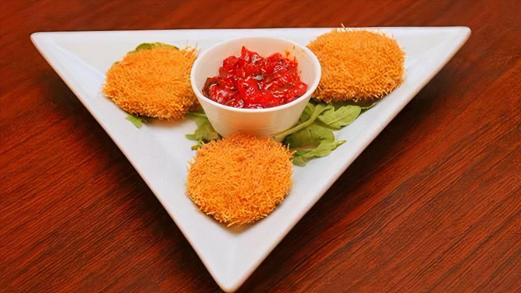 Dahi Ke Kabab · Yogurt dumplings with chopped onions, peppers coated with vermicelli and topped with tangy tomato chutney.