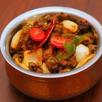 Achari Aloo · Potatoes cooked with ginger, garlic, onions, and pickled spices.