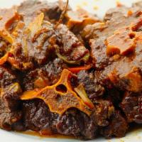 Stew Oxtail · Deliciously stewed oxtail braised with butter beans in a flavorful deep gravy spiced up prim...