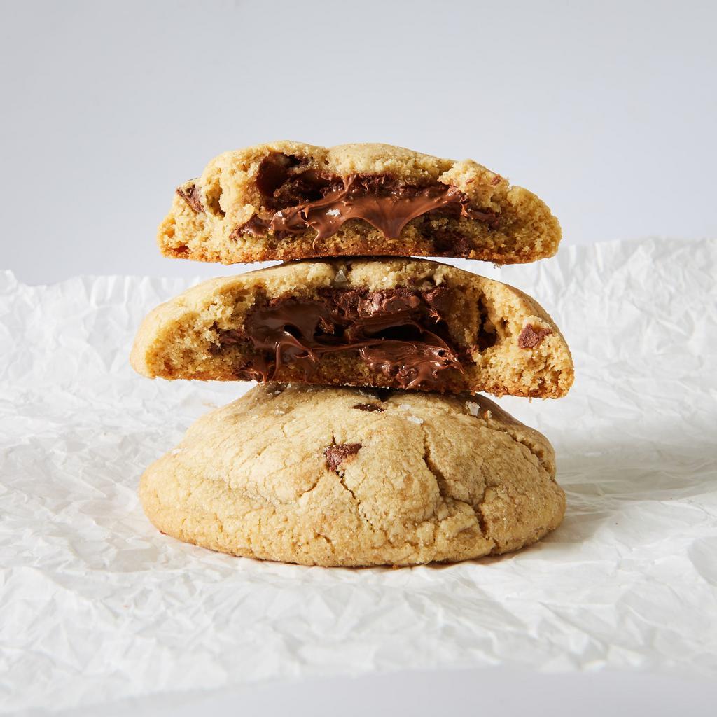 Nutella Sea Salt · Classic chocolate chip cookie with a soft Nutella filling, topped with flaky sea salt, dark chocolate chips, and chopped hazelnut giving a smooth nutty flavor.