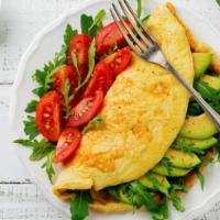 California Omelette · Hearty mushrooms, creamy avocado,  and locally grown tomatoes sauteed then topped with Peppe...