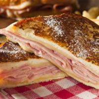 Monte Cristo · Scrumptious French toast dusted with powdered sugar, sliced ham, fresh turkey, Swiss cheese ...