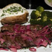 Char-Grilled Churrasco (Skirt Steak) With Two Sides · Topped with grilled red onions.