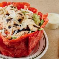 Mexican Taco Salad · Fresh romaine, pico de gallo and guacamole, served in a crispy tortilla shell, topped with s...