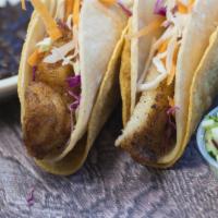 Blackened Fish Tacos · Pan blackened catfish with Monterey Jack cheese, shredded cabbage and carrots, cucumber sals...