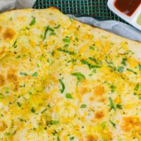 Garlic Naan · Freshly baked white bread topped with garlic and fresh butter.