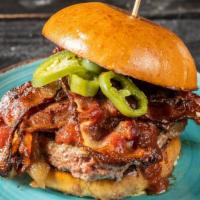 Blueprint Signature Burger · Grilled triple-blend burger with smoky bacon. Sautéed mushrooms, onion jam, jalapenos, espre...
