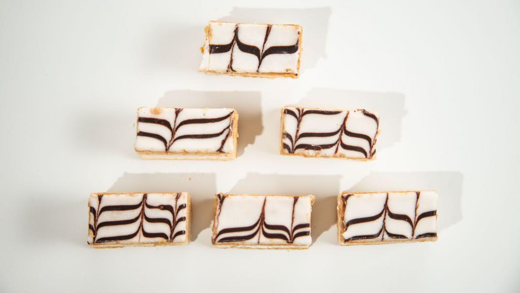 Napoleon (24) · Light, crispy puff pastry layers with a creamy pastry cream topped with fondant.