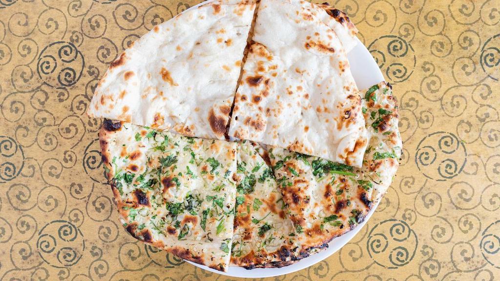 Tandoori Naan · Soft white bread baked in a clay oven.