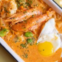 Chupe De Camarones · Peruvian shrimp bisque, choclo, yellow potato, faba beans, fried egg, queso fresco, root veg...