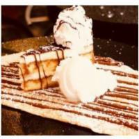 The Tiramisu Crepe · A whole piece of tiramisu cake is centered and warmed inside a crepe, then topped with Nutel...