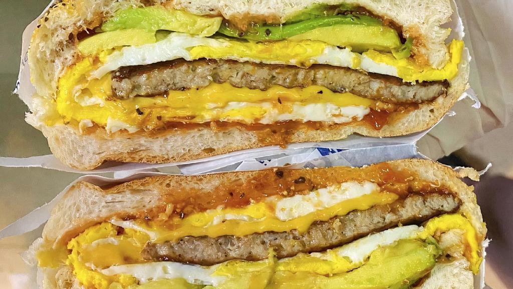 Sausage Egg And Cheese W/ Avocado · Breakfast Sausage Patty, Fried Eggs, American Cheese W/ Avocado on A Roll.