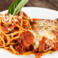Chicken Parmigiana · Chicken cutlet with tomato sauce and melted cheese.