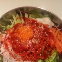 Hwe Dup Bap · Assorted raw fish, rice, spring mix, and vegetable, with hot pepper sauce, sesame oil, and m...