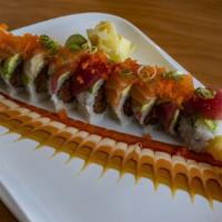 Rainbow Roll · Inside: Avocado, cucumber, and crab. Top: Tuna, salmon, whitefish, and shrimp with masago.