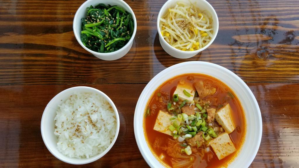 Kimchi Jjigae (Stew) Meal · Spicy Korean Stew made with kimchi, pork, tofu, onion, and scallion. Served with a bowl of white rice and 2 side dish (toppings) of your choice
