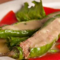 Stuffed Italian Long Peppers · Peppers stuffed with ground sweet sausage, mozzarella cheese and topped with a white wine sa...