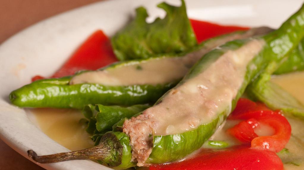 Stuffed Italian Long Peppers · Peppers stuffed with ground sweet sausage, mozzarella cheese and topped with a white wine sauce.