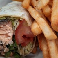 Jerk Salmon Wrap & Fries  · A grilled tortilla loaded with (6 oz) of seasoned grilled Alaskan salmon, fresh lettuce, tom...