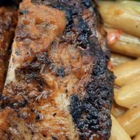 Jerk Chicken  · Served with your choice of rasta pasta, rice and peas, mixed vegetables, and mashed potatoes...