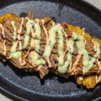 Tostones · Shredded beef, pork or chicken, creole sauce, home made pink and green sauce. / Carne de res...