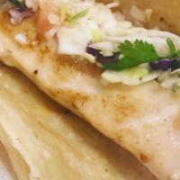 Fish Taco · Soft corn tortilla stuffed with grilled catch of the day. Topped with homemade slaw.