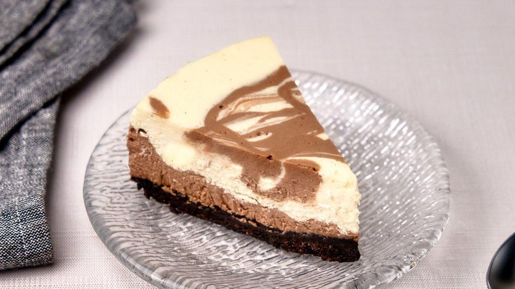 Nutella Cheesecake Slice · Nutella marble cheesecake with oreo crust.