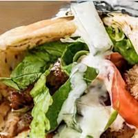 Gyro On A Pita · Serve with lettuce and tomato and white sauce