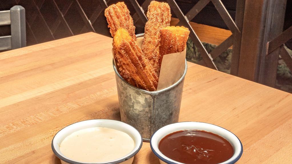 Churros · Served with two dipping sauces: Mexican chocolate and dulce de leche whipped cream.