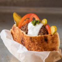 Falafel · Falafel burger with tomatoes, pickles, sour cream, green spicy, add tahini