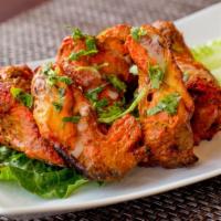 Tandoori Chicken Wings · Chicken wings marinated in spiced yogurt and grilled in tandoor oven, served with house chut...